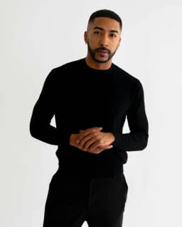 Man wearing a black sweater against a light studio background — illustrative style reference